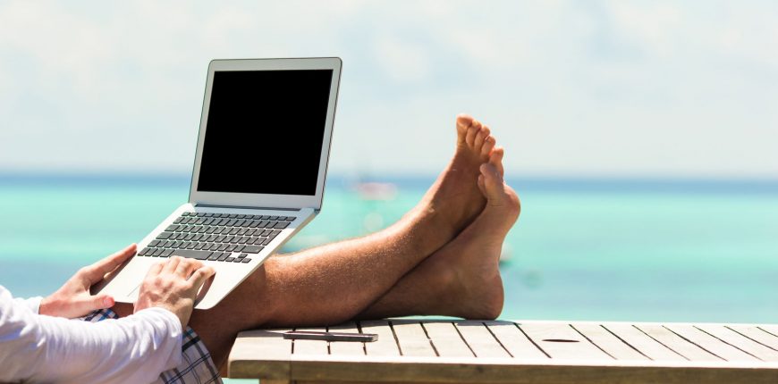 39665502 - young man with tablet computer during tropical beach vacation